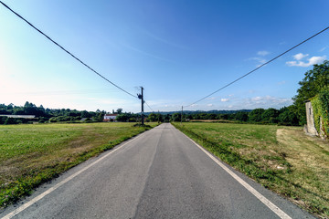 Perspective view of a regional road in Galicia (Spain), with the sky with very few clouds