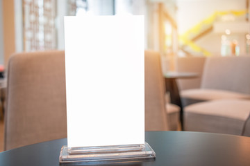 Mock up white Label for blank menu frame in Bar restaurant cafe., Stand for booklets with  sheets paper tent card on table cafeteria, blurred background insert for text of customer. Space for texting.