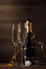Picture of two glasses with champagne, bottle, cork