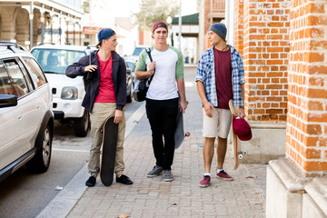 Fototapeta premium Teenage friends walking at the street