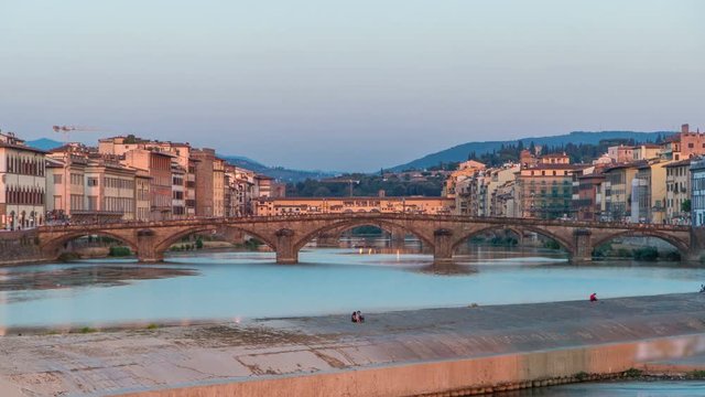 Scenic Sunset Skyline timelapse View of Tuscany City, Housing, Buildings and Ponte alla Carraia and Arno River, Florence, Italy.