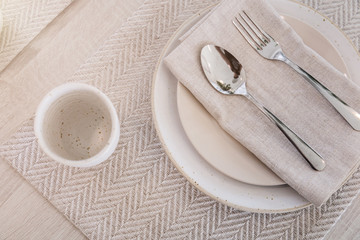 dining set with dish and spoon on white clean napkin