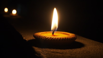 burning flat candle at night isolated on dark background