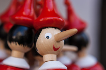 Wooden Pinocchio's figurines sold as souvenirs in Gubbio, Umbria, Italy