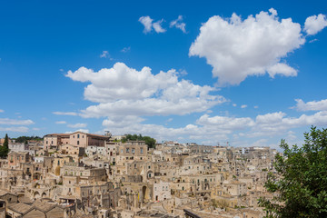 Fototapeta na wymiar Panoramic view of the ancient town of Matera (Sassi di Matera), European Capital of Culture 2019, under blue sky, Basilicata, southern Italy