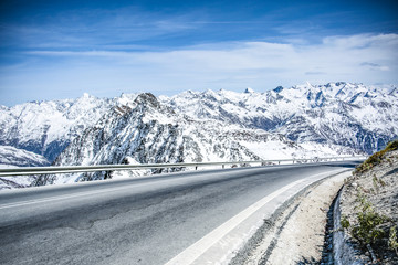 Winter road with mountain view. Asphalt with a place for your decorations. December sky above the...