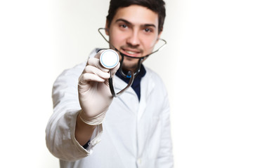 beautiful young doctor in a dressing gown with a stethoscope on a white background in the studio, stethoscope, examination,