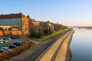 Torun city and river promenade in foggy morning. View from the Pilsudski bridge.