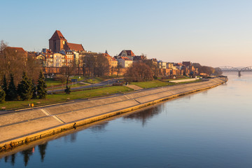 Fototapeta premium Torun city and river promenade in foggy morning. View from the Pilsudski bridge.