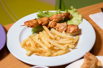 Grilled chicken on bamboo skewers, close up view. Chicken kebab with cartilage fry in the plate .