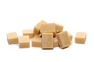 Brown cane sugar cubes isolated on white background
