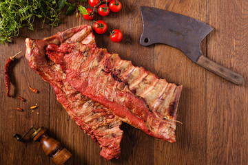 Smoked ribs on wooden table.