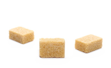 Brown cane sugar cubes isolated on white background