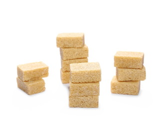 Brown cane sugar cubes isolated on white background