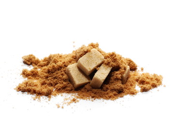 pile unrefined light brown cane sugar cubes on white background