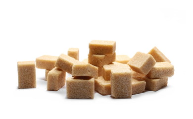 Brown cane sugar cubes isolated on white background