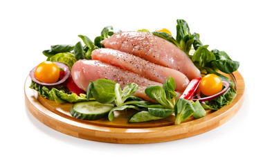 Raw chicken breasts on cutting board