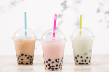 Fefreshing iced milky bubble tea with tapioca pearls in plastic cup