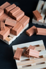 Close-up of fallen bricks on wooden pallet.
