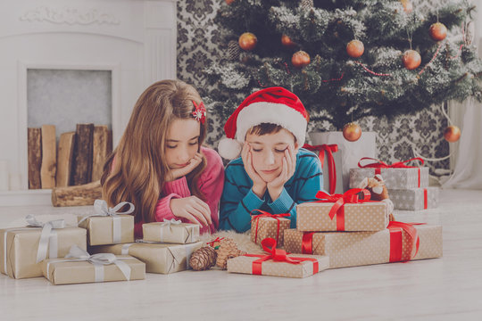 Beautiful children and christmas present indoors