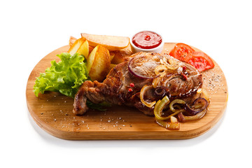 Grilled steak with potatoes on cutting board