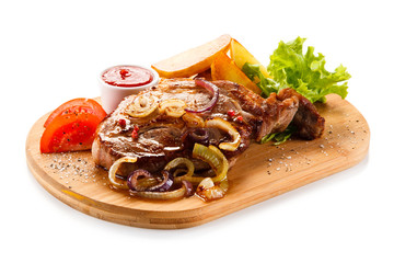 Grilled steak with potatoes on cutting board