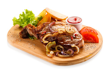 Grilled steak with potatoes on cutting board