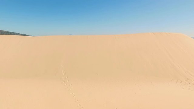 Aerial view of a big dune sand with ocean and Africa coast behind it. Delightful beach with nobody