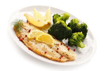 Fried fish fillet with broccoli on white background