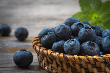Arrangement Blueberries in wicker on the table