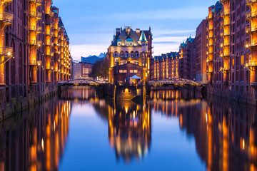 Speicherstadt during twilight in Hamburg, Germany, reflection of lights and buildings on water in canal