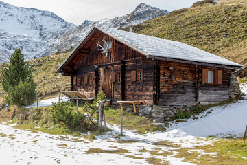 alpine hut in late autumn with first snow