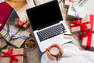 Woman shopping online with a credit card, top view