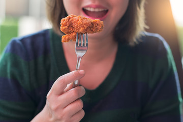 woman hand hold fried chicken for eat,girl with fast food concept