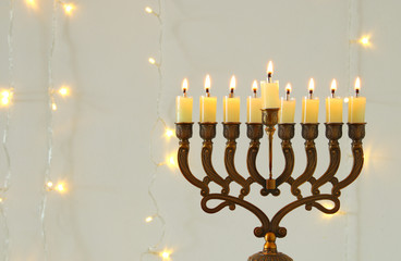 Fototapeta premium image of jewish holiday Hanukkah background with menorah (traditional candelabra)