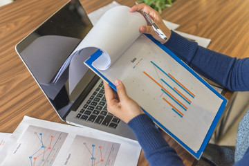 Sales manager checking sales reports in office