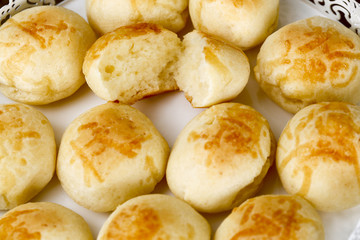 Portion of the famous Brazilian cheese bread on white tray