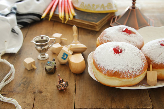 image of jewish holiday Hanukkah background with traditional spinnig top and doughnuts.
