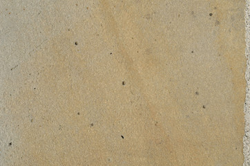 Beige color smooth stone surface as a background