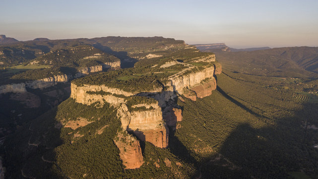Aerial view of colorful sheer cliffs above Sau reservoir near Tavertet in Catalonia, Spain