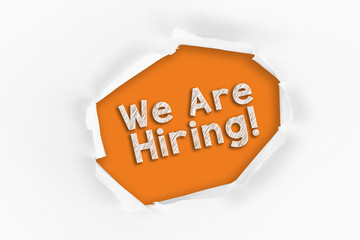 Torn paper with a We Are Hiring word on red background.