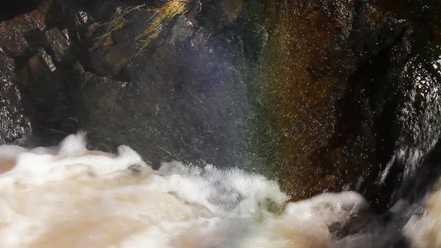 Spray of waterfall to form rainbows,  rainbow palette, bright picture, beauty of rafting
