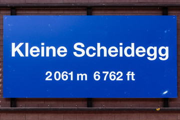 Blue nameplate of Kleine Scheidegg train station in Jungfrau region, Switzerland