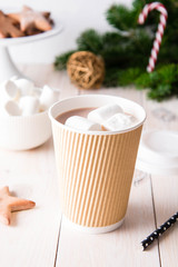 Cup of hot chocolate with marshmallows on white wooden background. Copy space.