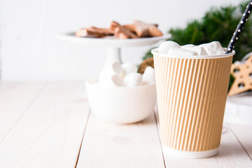 Cup of hot chocolate with marshmallows on white wooden background. Copy space.