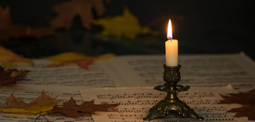 candle and sheet music