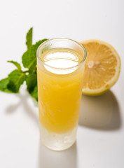 Traditional homemade lemon liqueur limoncello and fresh citrus