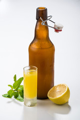 Traditional homemade lemon liqueur limoncello and fresh citrus