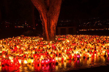 Graveyard candles on Polish cemetery during All Saints Day at night.