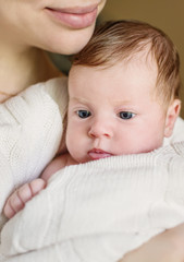 Happy mother holding a newborn baby